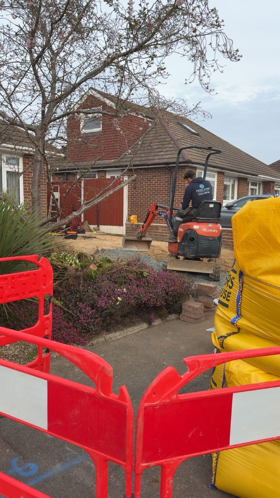 Mini excavator carrying out drainage groundworks at a Kent property