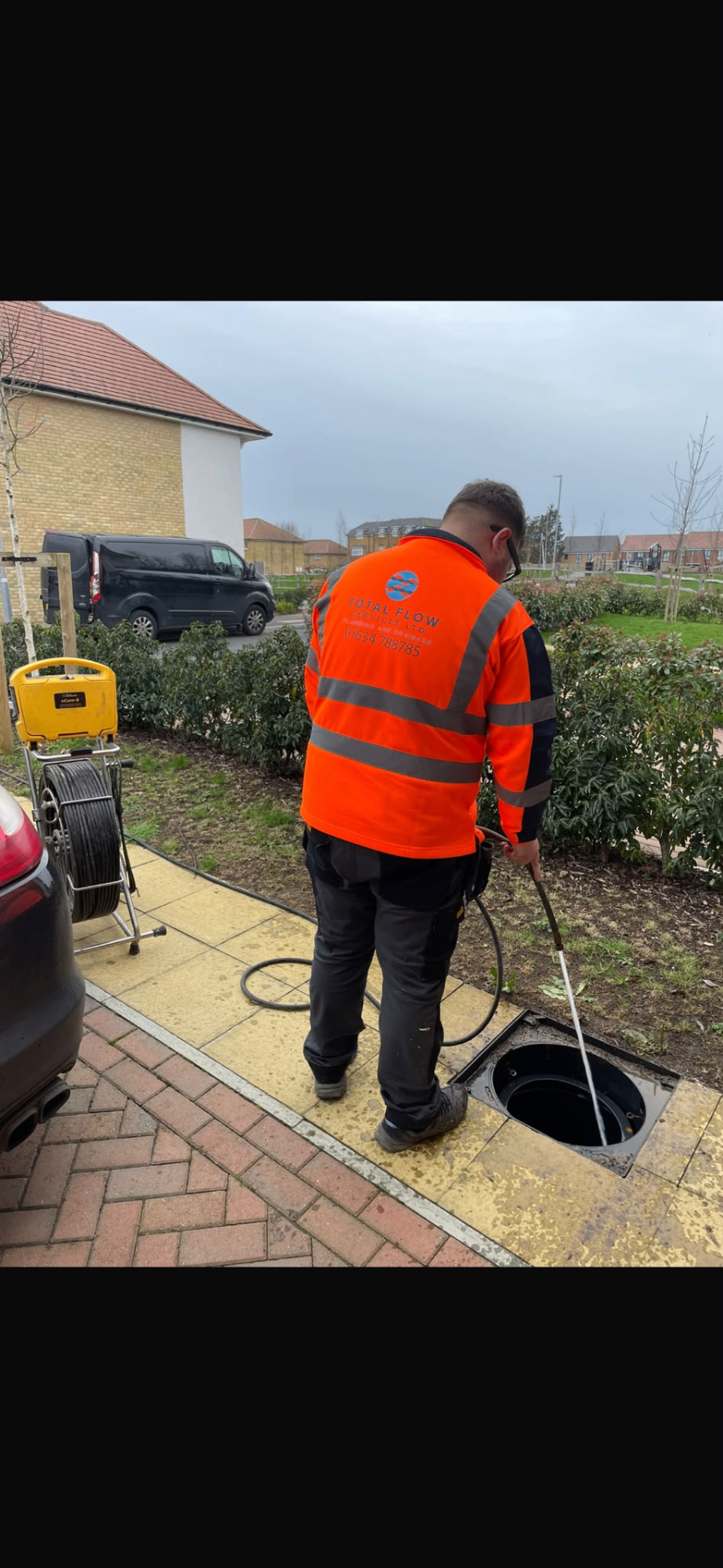 Total Flow Services drainage engineer setting up high-pressure jetting equipment from the work van on a Kent driveway